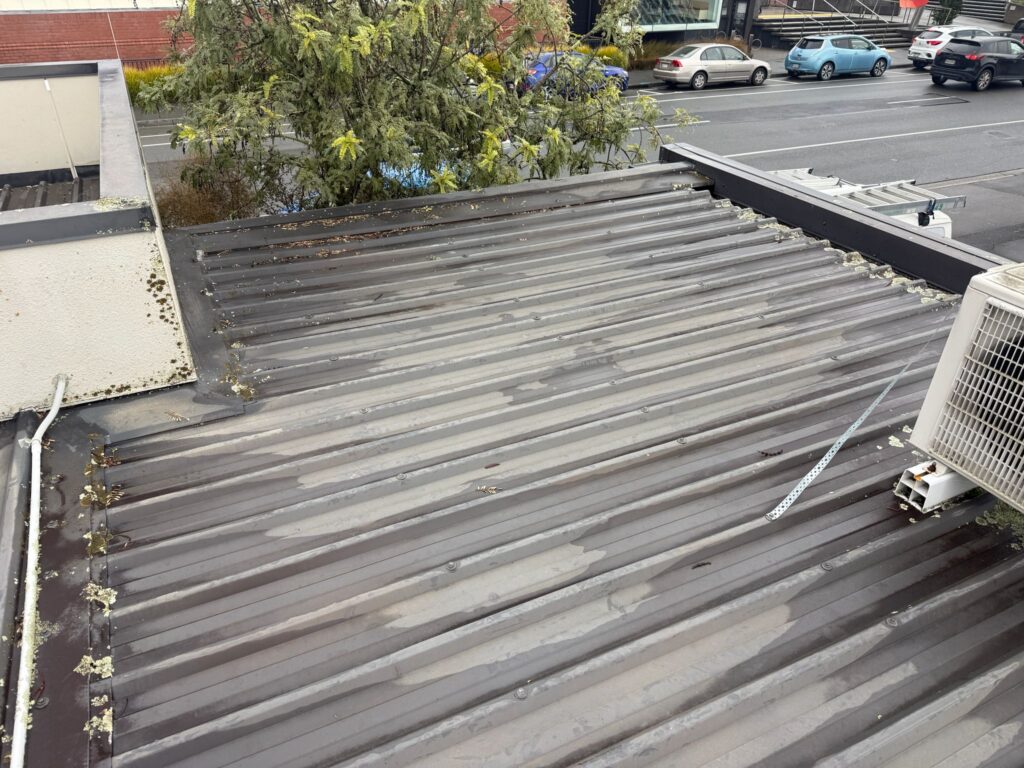Existing trapezoidal metal roof before overlay installation